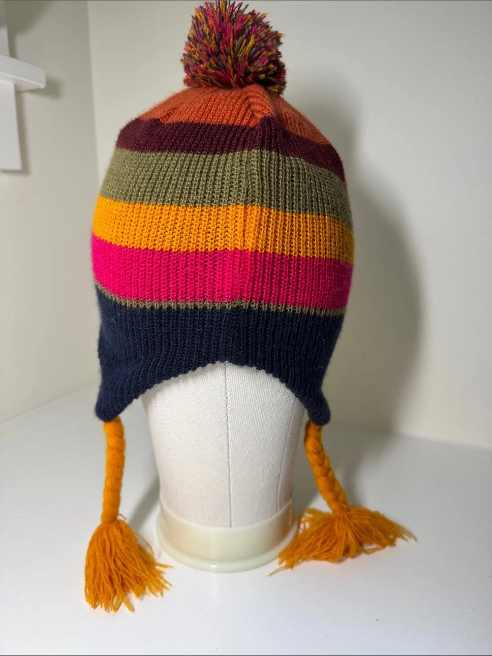 Kids REI acrylic knit beanie hat with pompom and ear flaps.